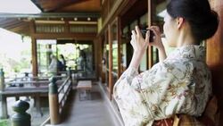 Woman Wearing Kimono Takes Photograph Stock Footage
