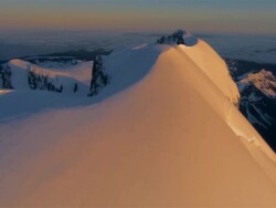 LOW AERIAL, Snow capped  Mt. Tutoko at sunset, Fiordland National Park, New Zealand Stock Footage