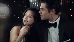 Young starlet leans on man's shoulder and stares out at paparazzi in back of limousine at awards show Stock Footage