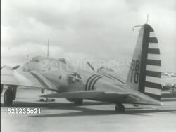 MOT 1939: NEW HEAVY BOMBERS: Boeing B-17 'Flying Fortress' being pulled slowly out of hangar (tail code BB10), men driving small open bomb carts toward angle parked B-17s (#51 & #50 FG), WS B-17 bomb bay doors slowly opening w/ bombs lined up on cart FG. Instructional Video
