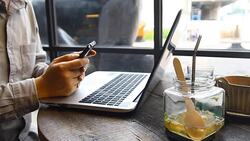 businessman hand hold phone and use laptop Stock Footage