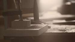 Carpenter hammering nail in piece of wood Stock Footage
