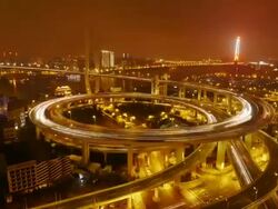 Nanpu Bridge, Huangpu River, night to day, dawn, traffic, city lights, Shanghai, China Stock Footage