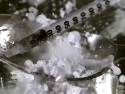 MS SLO MO Drops of water being fallen in spoon with drug powder and Syringe / Vieux Pont, Normandy,  France Stock Footage