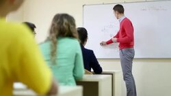 Professor writes on white board and teaching Stock Footage