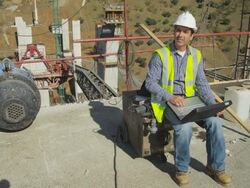 HA mature engineer sitting in construction site, working on laptop computer Stock Footage