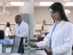 Female Doctor filling out forms Stock Footage