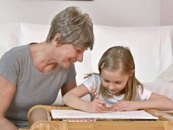 HD DOLLY: Adorable Girl Drawing With Her Grandmother Stock Footage