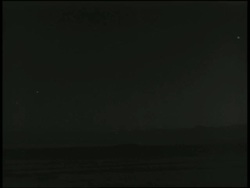 B/W 1955 long shot atomic bomb exploding in test over horizon / Nevada / documentary Stock Footage