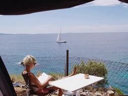 LS DS Woman Reading A Book In The Camp Stock Footage