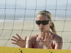 ECU CU ZI portrait of a female beach volleyball getting ready to block at the net. Stock Footage