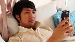 Man reading a text message while in bed Stock Footage