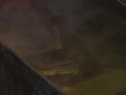 Molten gold ingots being cooled by smelter News Clip