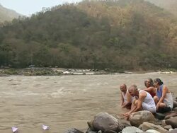 Five senior people floating paper boat in river, Ganges River, Rishikesh, Uttarakhand, India Stock Footage
