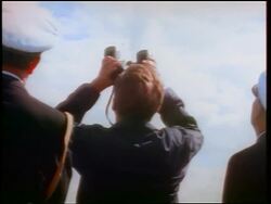 1960s REAR VIEW John Kennedy looking up with binoculars / watching missile / officer in foreground Stock Footage