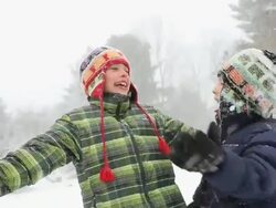 MS ZO Boys trying to catch snowflakes during snow storm / Yarmouth, Maine, USA Stock Footage