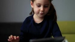 Little cute girl using tablet PC Stock Footage