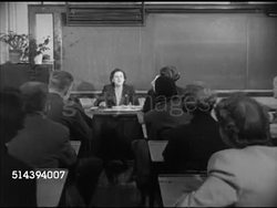 1952: MONTCLAIR HIGH SCHOOL PARENT TEACHER CONFERENCE: VS Montclair H.S. building in New Jersey. INT VS Teacher discussing w/ parents during parent-teacher conference in classroom, talking about improving present course of study (SOT). NJ, education Instructional Video