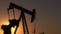 An oil pump pumps slowly in a North Dakota filed. Stock Footage