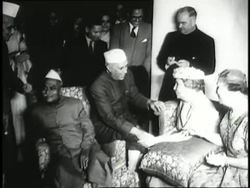 Indian Prime Minister Jawaharlal Nehru greets and sits down with Helen Keller and her interpreter Polly Thomson who uses sign language with her. News Clip