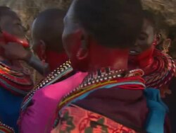 Maasai Ceremony - Women apply red face paint in preparation for ceremony, WITH AUDIO Stock Footage