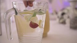 Person adding strawberry in refreshing drink at wedding Stock Footage