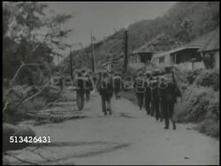 1944: BATTLE OF GUAM: VS U.S. 3rd Marine Division &amp; 77th Infantry Regiment soldiers marching on capital city Agana, soldiers cautiously advancing through destroyed city, damaged Spanish church. World War II, WWII, Pacific Front, Hagatna Instructional Video