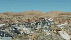 Wide panning shot of landfill garbage in desert landscape / Moab, Utah, United States Stock Footage
