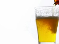 Refreshing beer into rotate glass on white background Stock Footage