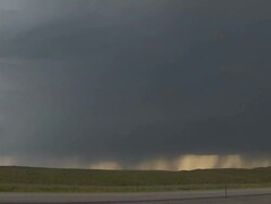 Pan left across severe thunderstorm, supercell thunderstorm with rain shafts and rain cores under storm. Stock Footage