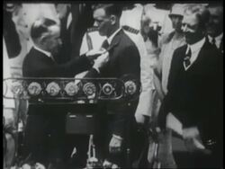 B/W 1927 Calvin Coolidge pinning Distinguished Flying Cross medal on Charles Lindbergh Stock Footage