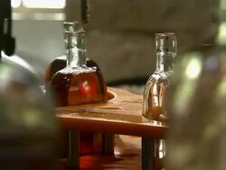 Close up of bottles of bourbon moving through machines in bottling plant. Stock Footage