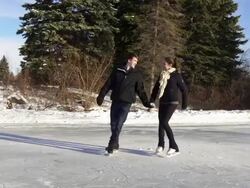 Young adult couple skating together in winter on ice.. Stock Footage