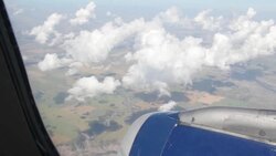 Plane Flying Above Clouds Stock Footage