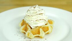 put whipping cream and sprinkle cocao powder on top of the waffle . Front view. Slow motion. Stock Footage