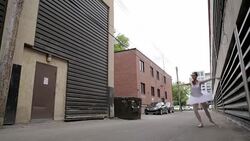 Ballerina practicing leaping in urban alley Stock Footage