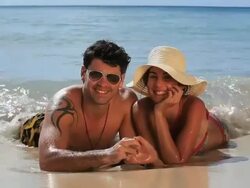 Good Looking happy Young Couple lying in the surf smiling Stock Footage