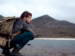 Backpacker resting at a lake Stock Footage