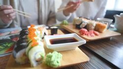 Happy couple eating sushi rolls in japan restaurant Stock Footage
