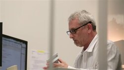 Older businessman shows calculator to client in small private corporate office Stock Footage