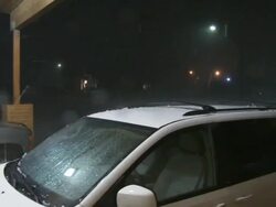 MS PAN ZI Shot of storm with vehicles parked under carport at night / Lemmon, South Dakota, United States Stock Footage