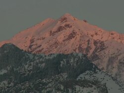 WS sunset glow reflecting off of snow capped mountain / Utah, United States Stock Footage