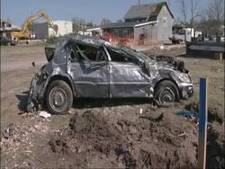 MS car wrecked by tornado damage, with damaged house in background, USA Stock Footage