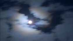 The full moon shines bright behind wispy white clouds. Stock Footage
