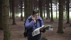 Man with Backpack and map searching directions Stock Footage