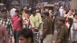 Police officers direct crowds of motor and foot traffic in  India. Stock Footage