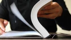 man hand opening and flipping book at table Stock Footage