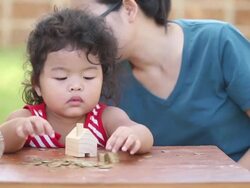 Cute boy with mother learn to count money Stock Footage