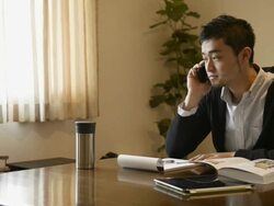 MS Shot of furniture designer using smartphone in room / Kyoto, Japan Stock Footage