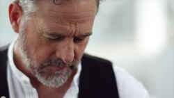 Artist dipping brush in red color Stock Footage